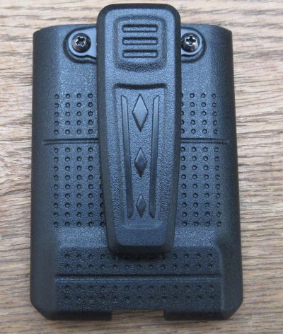 amherst-a66-battery-with-belt-clip-fitted Belt Clip for A66 Walkie Talkie Battery, black plastic with textured grip and screw fixings, displayed on a wooden surface.