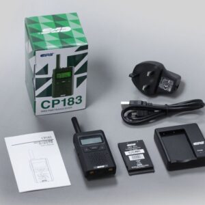 The CPS Telecom CP183 Tiny PMR446 Radio, its battery, charging dock, power adaptor, USB cable, user manual, and product box are neatly arranged on a flat surface.