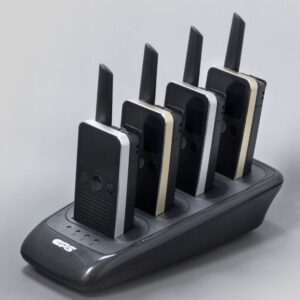 cp228-multi-charger-in-use-med Four CPS Telecom radios are upright in a CS28 Four Slot Charger, set against a plain light background.