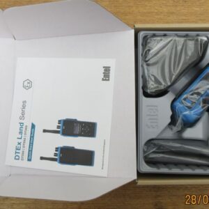 An open box containing an Entel DT982 Atex 2c walkie-talkie set with the radio, aerial, charger, user manual, and accessories neatly packed inside.
