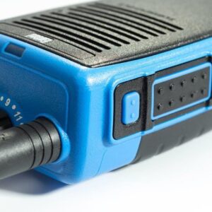 Close-up of the Entel DT982 Atex 2c walkie-talkie in blue and black, featuring control knobs, a side button, and a textured grip.