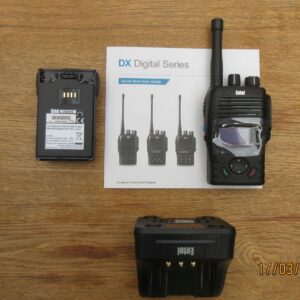 An Entel DX485 Digital/Analogue Walkie Talkie Radio, battery, charging dock, and quick start guide are displayed on a wooden surface.