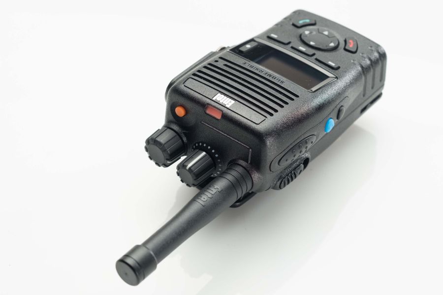 The Entel DX485 Digital / Analogue Walkie-Talkie Radio is a black two-way transceiver featuring knobs, buttons, a display screen, and an aerial, shown on a white background.