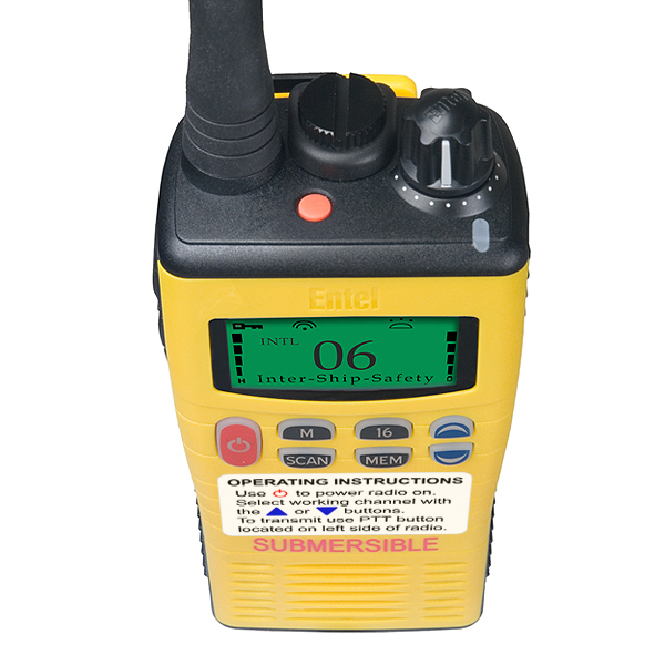 entel-ht649-top-view The Entel HT649 Marine VHF GMDSS Emergency Walkie-Talkie is a yellow handheld radio with a display showing “06 Inter-Ship-Safety” and a front label with operating instructions and “SUBMERSIBLE.”.