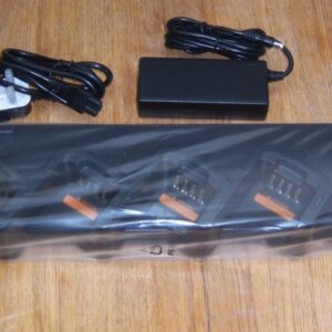  A Hytera PD7xx Battery BL2008/BL2006 multi-unit charger with four slots, power adaptor, cable, and instruction manual displayed on a wooden surface.