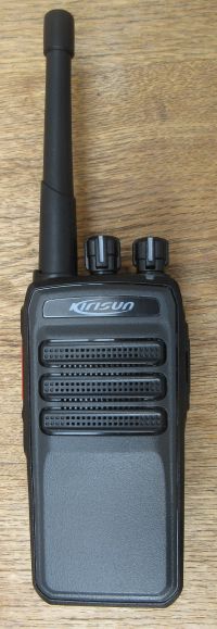 The Kirisun DP405 Digital / Analogue Two-Way Radio, black with an aerial, two control knobs, and speaker grilles, is placed on a wooden surface.