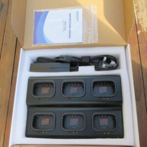 The Kirisun PT568 Six Slot Multi-Charger box includes a charging station with six battery slots and indicator lights, a power cable, an adaptor, and an instruction manual.