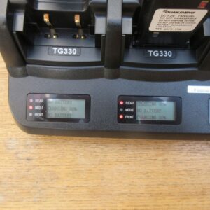 Close-up of a Quansheng TG330 Twelve Slot Charger on a wooden surface, with two digital displays reading "CHARGING 80%" and "NO BATTERY".